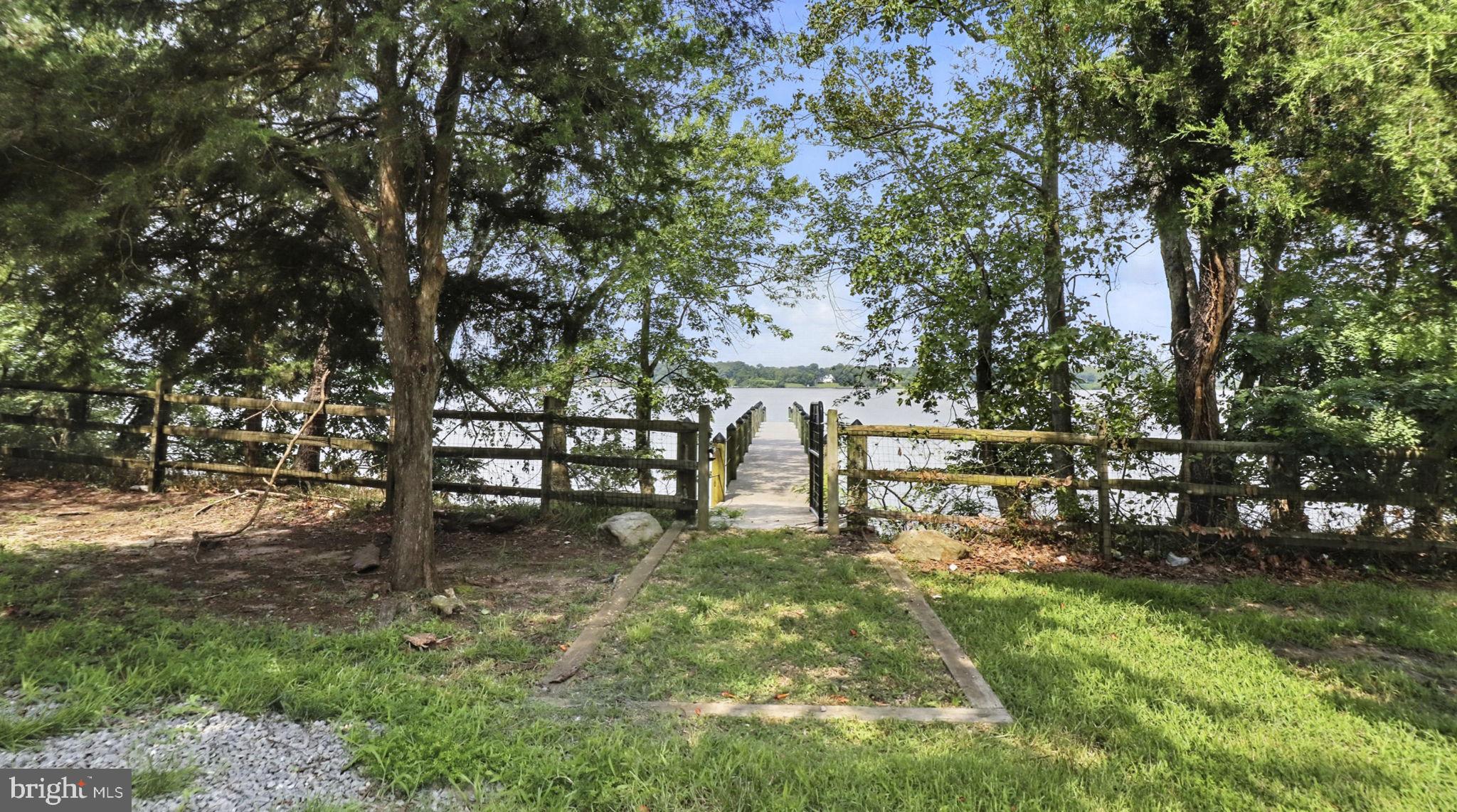 11305 Riverview Road Fort Washington, MD 20744 - Photo 30 of 59 a view of a bench in a yard with wooden fence