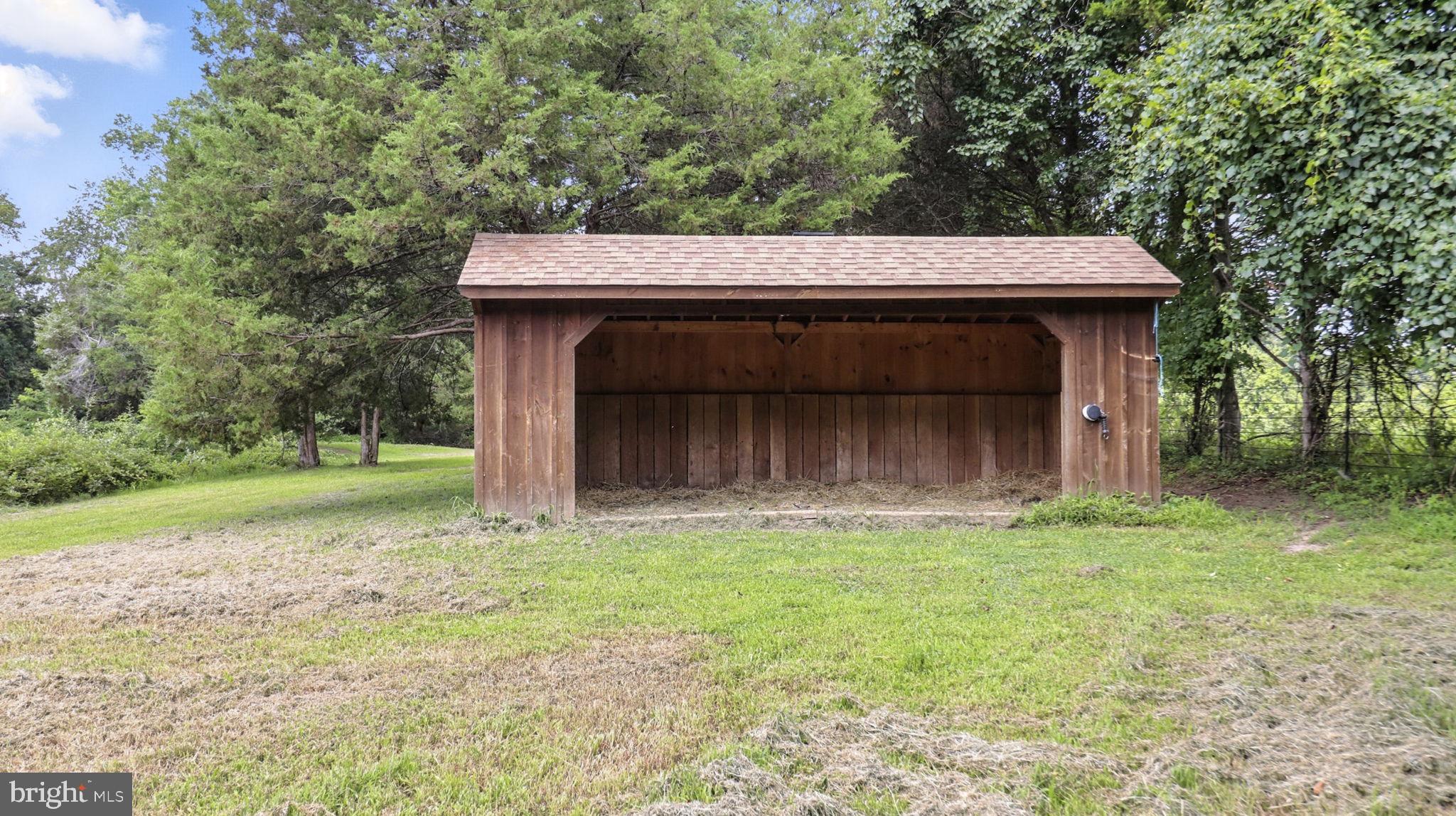 11305 Riverview Road Fort Washington, MD 20744 - Photo 41 of 59 a backyard of a house with large trees and a small barn