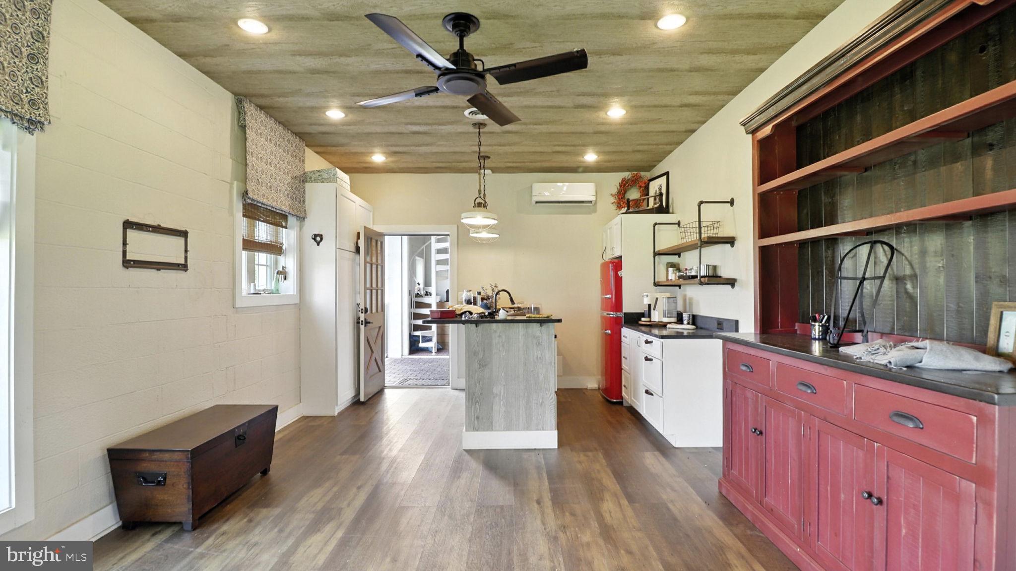11305 Riverview Road Fort Washington, MD 20744 - Photo 10 of 59 a view of a kitchen with kitchen island wooden floors appliances and furniture