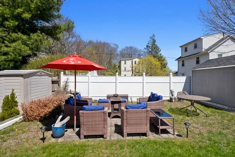 a view of a backyard with sitting area and furniture
