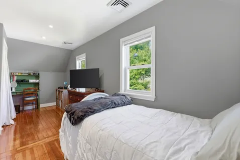 a bedroom with a bed and a tv
