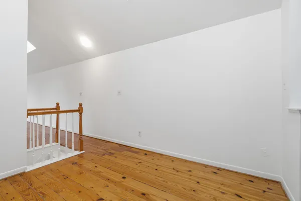 a view of hallway with wooden floor