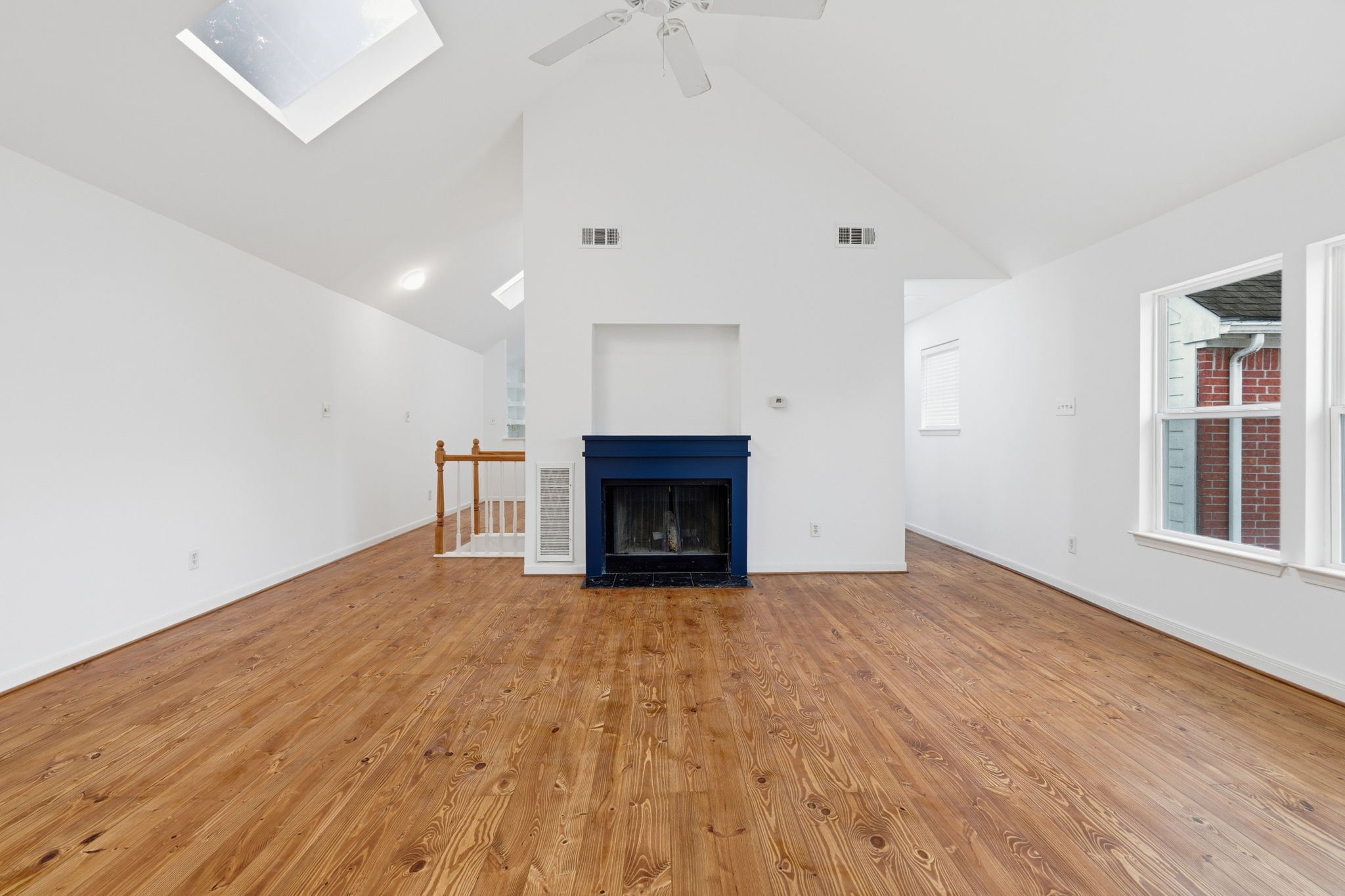1616 Kipling Street, Unit C Houston, TX 77006 - Photo 22 of 34 a view of an empty room with wooden floor fireplace and a window