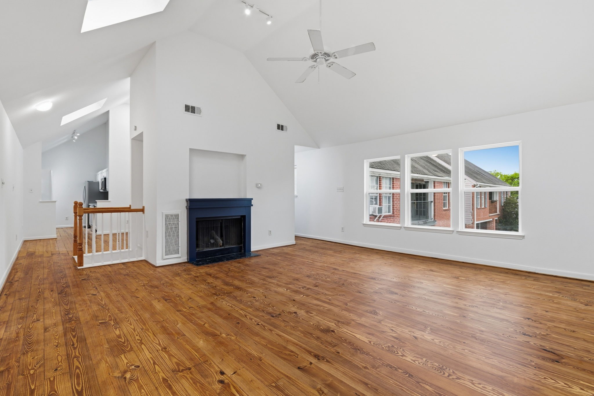 1616 Kipling Street, Unit C Houston, TX 77006 - Photo 23 of 34 a view of an empty room with wooden floor fireplace and a window