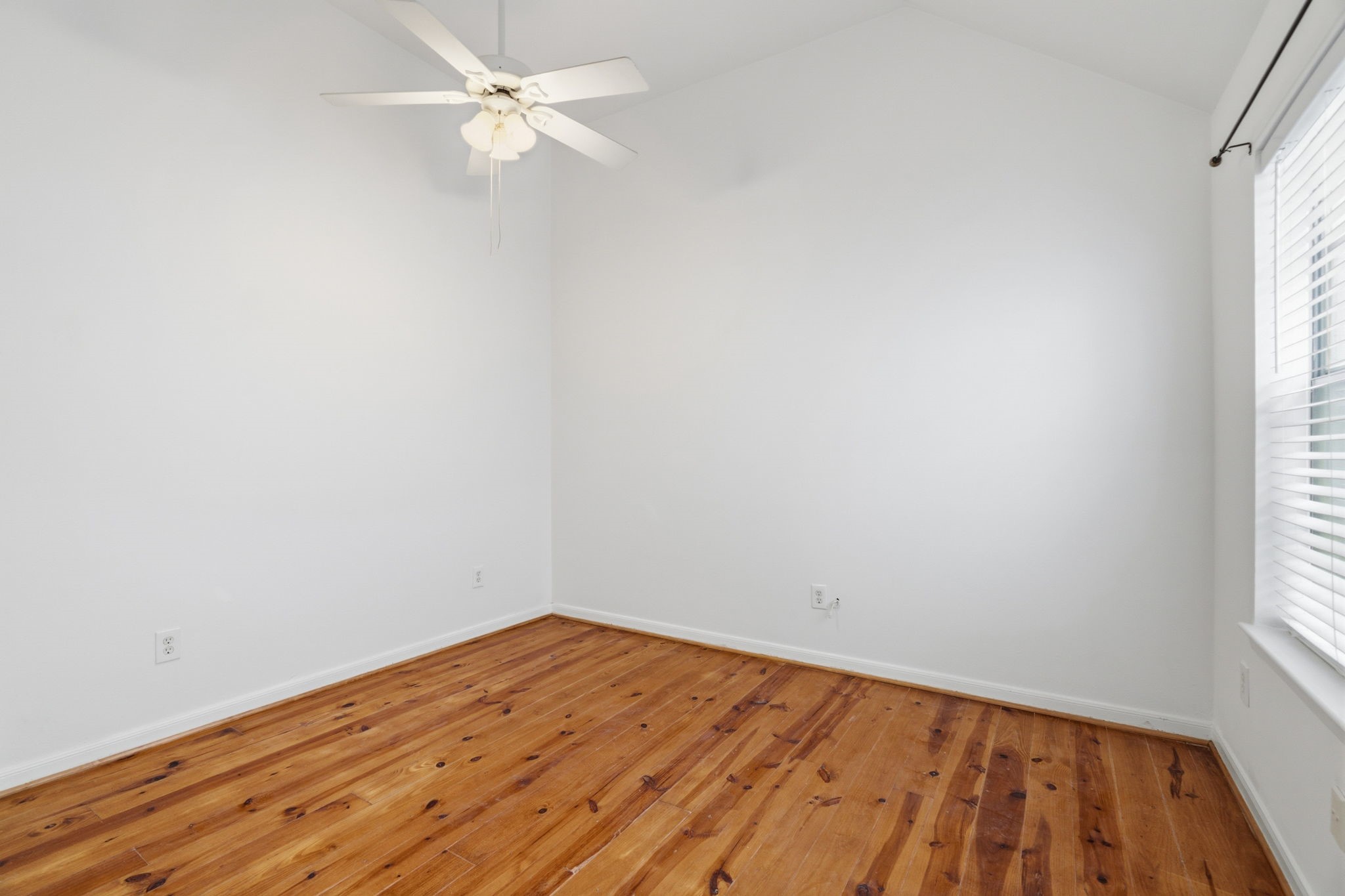 1616 Kipling Street, Unit C Houston, TX 77006 - Photo 25 of 34 an empty room with a window and wooden floor