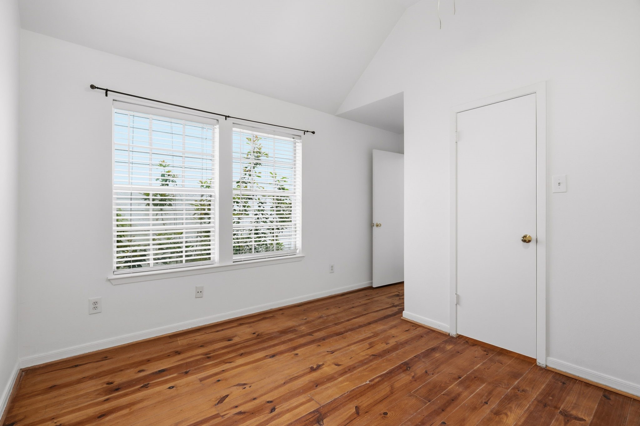 1616 Kipling Street, Unit C Houston, TX 77006 - Photo 26 of 34 a view of an empty room with wooden floor and a window