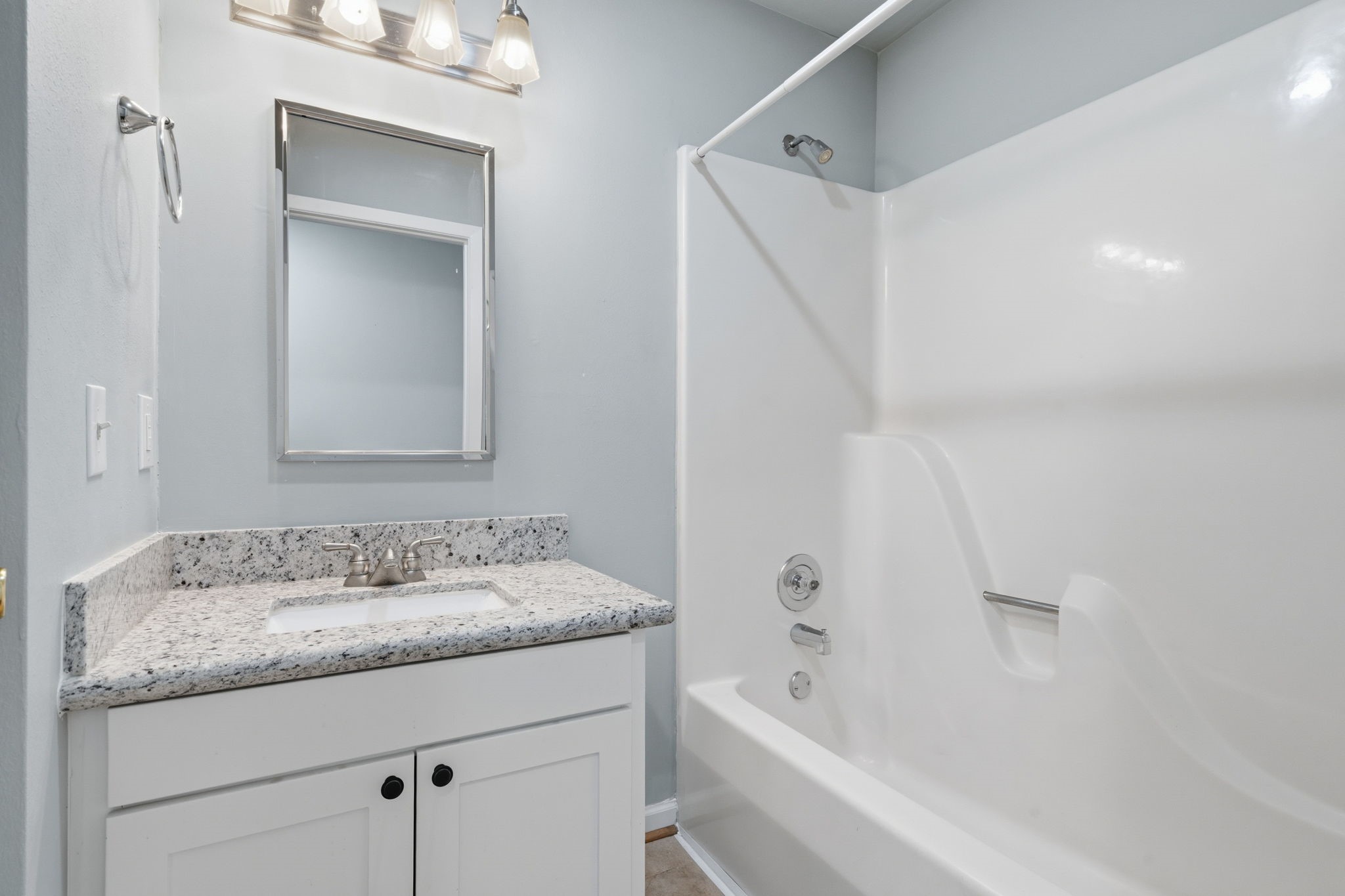 1616 Kipling Street, Unit C Houston, TX 77006 - Photo 27 of 34 a bathroom with a granite countertop sink a mirror and a bathtub