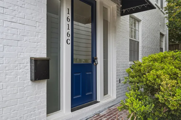 a view of a door of the house and front view of a house