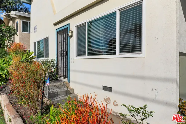 a view of house with backyard and sitting area