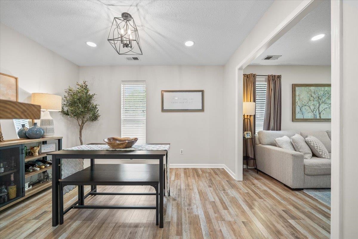 7300 Country Side Road Memphis, TN 38133 - Photo 9 of 22 Spacious open-concept living area featuring wood-finish flooring, recessed lighting, and a contemporary geometric light fixture