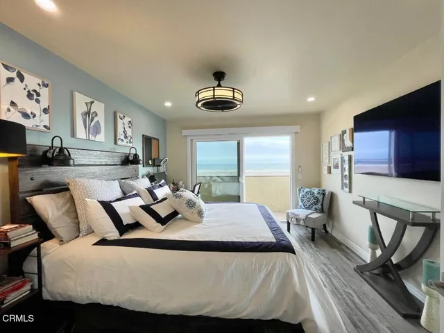 a bedroom with bed and wooden floor