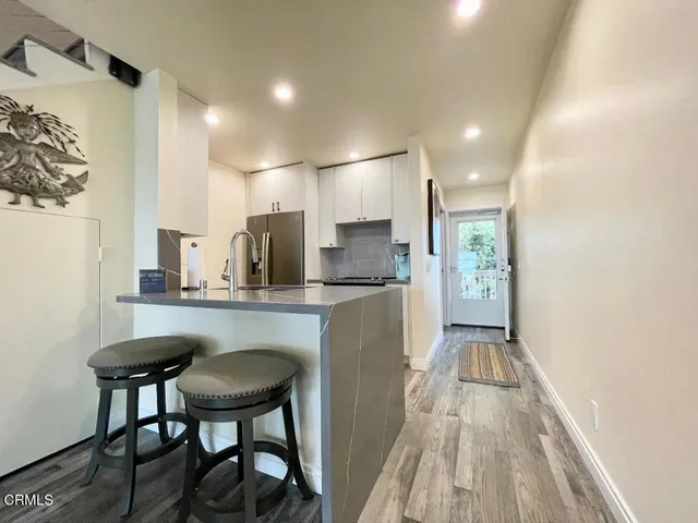 a kitchen with sink cabinets and dining table
