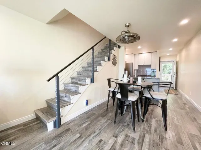 a view of a dining room with furniture and wooden floor