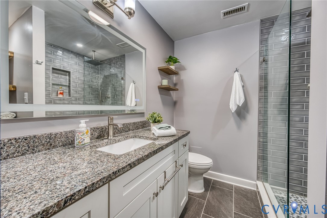 112 Water Pointe Court Midlothian, VA 23112 - Photo 20 of 32 a bathroom with a granite countertop sink a toilet and mirror