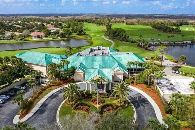 an aerial view of residential houses with outdoor space and lake view