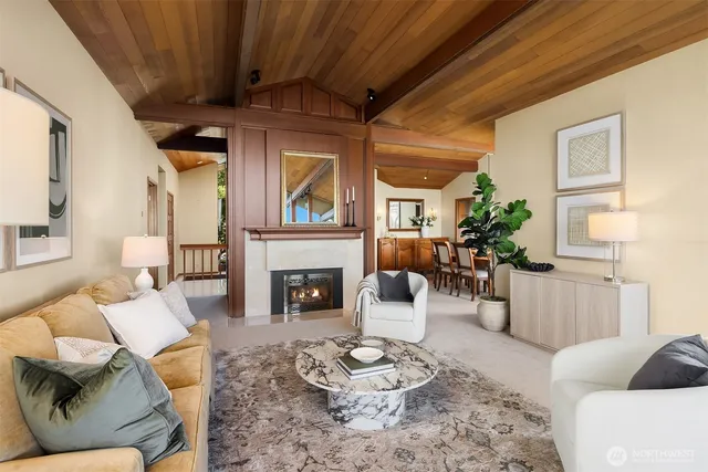 a living room with furniture and floor to ceiling windows