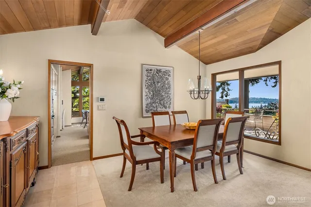 a kitchen with stainless steel appliances granite countertop a sink a stove and a wooden cabinets