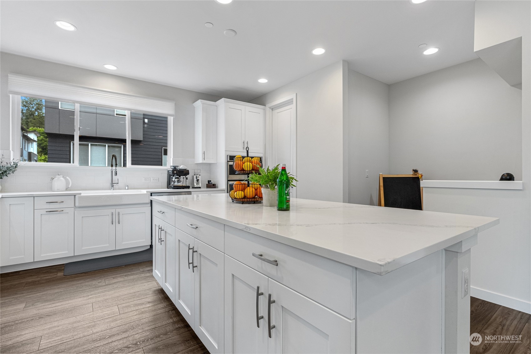 616 237th Place Southeast, Unit F Bothell, WA 98021 - Photo 14 of 27 a kitchen with kitchen island white cabinets and white appliances