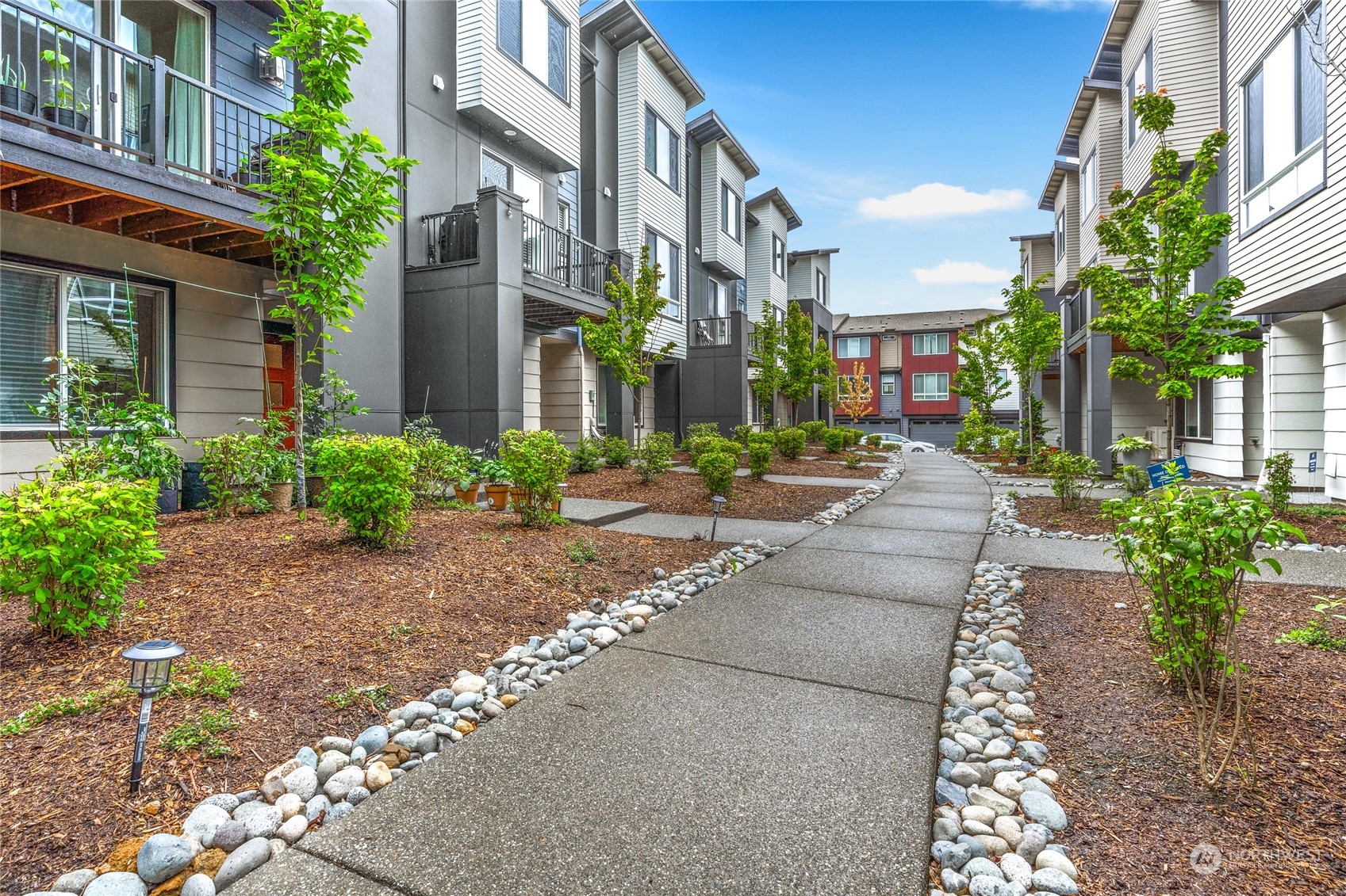 616 237th Place Southeast, Unit F Bothell, WA 98021 - Photo 2 of 27 a view of a building with garden