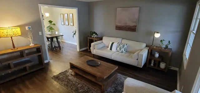 a view of a dining room with furniture and a potted plant