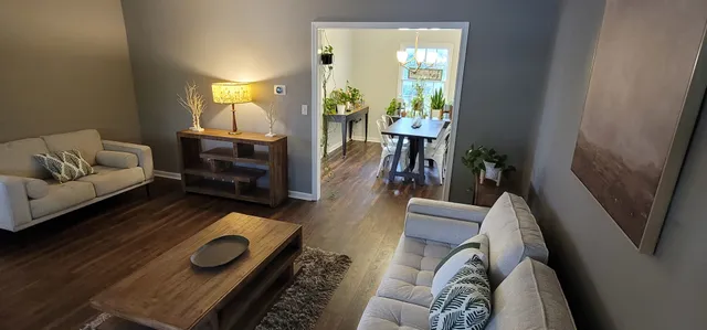a view of a livingroom with furniture window and wooden floor
