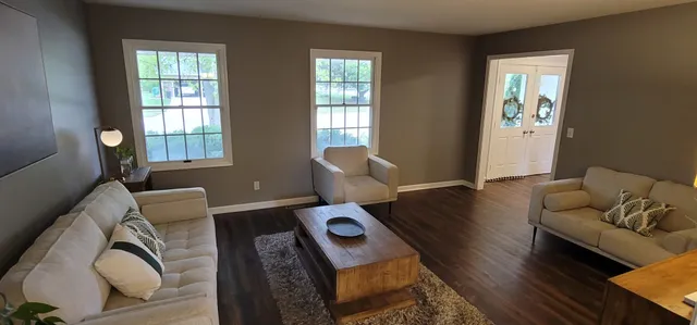 a view of a dining room with furniture and a window