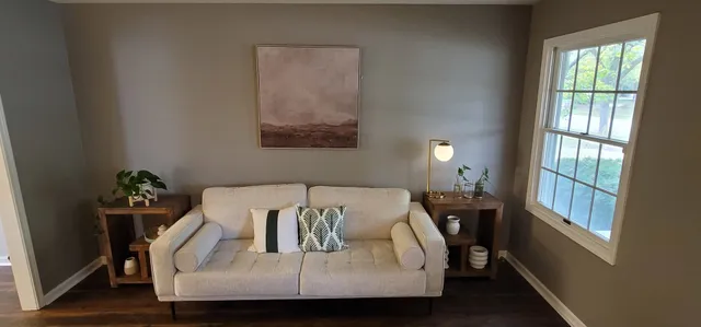 a living room with furniture and a fireplace