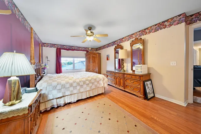 a bedroom with a bed dresser and a window