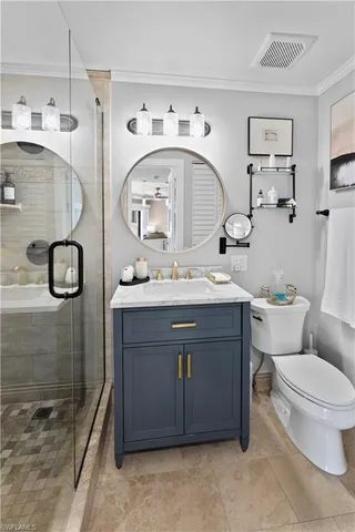 a bathroom with a sink vanity mirror and toilet