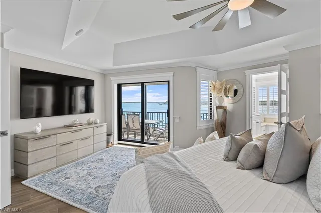 a bedroom with a large bed and a flat screen tv