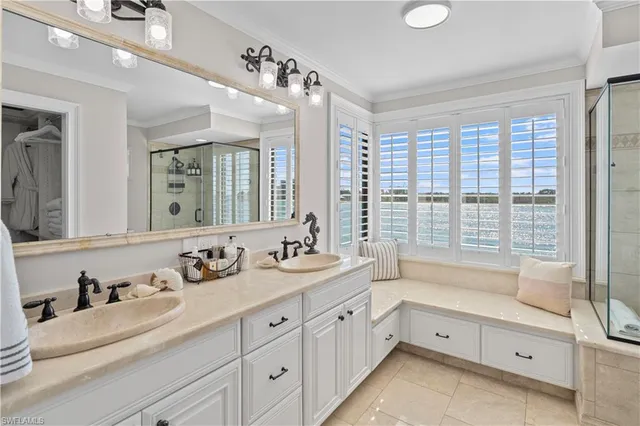 a spacious bathroom with double sink a two mirror a next to a window