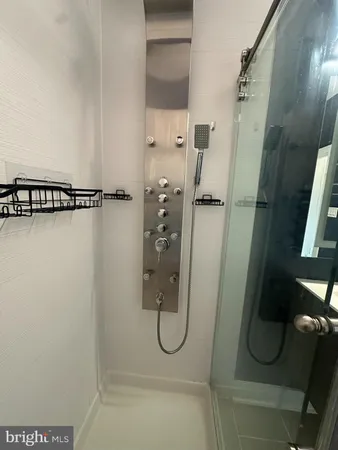 a bathroom with a sink a mirror and a shower