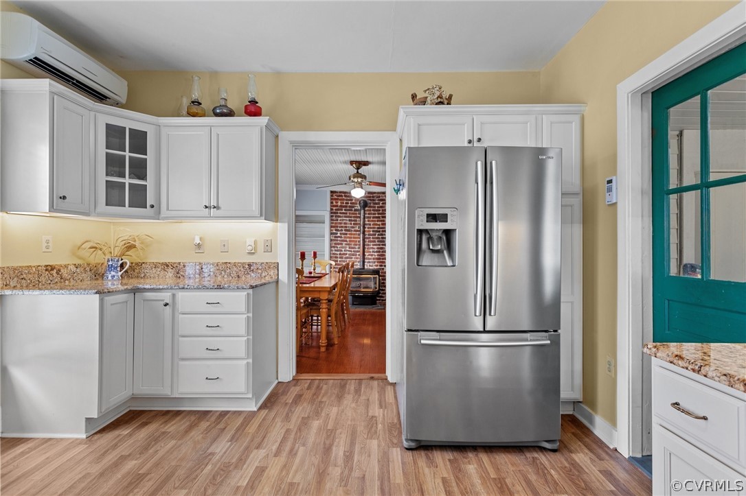 4851 Three Chopt Road Louisa, VA 23093 - Photo 18 of 39 a kitchen with granite countertop a refrigerator stove and wooden floor