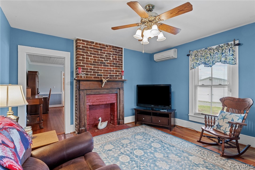 4851 Three Chopt Road Louisa, VA 23093 - Photo 22 of 39 a living room with furniture a flat screen tv and a fireplace