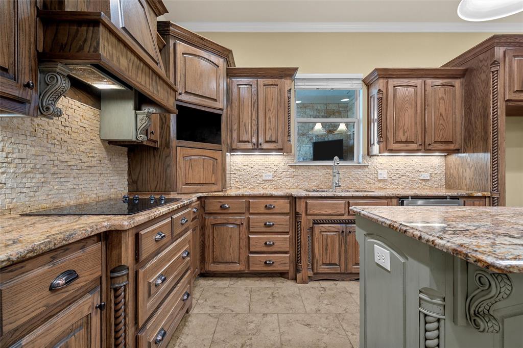 7030 Flagstone Circle Waco, TX 76657 - Photo 11 of 40 a kitchen with granite countertop a sink stove and cabinets