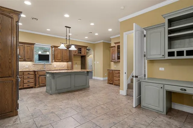 a large kitchen with a large counter top appliances and cabinets