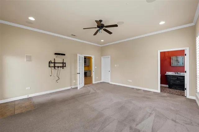 a view of empty room with ceiling fan