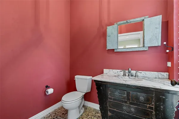 a bathroom with a sink a toilet and mirror