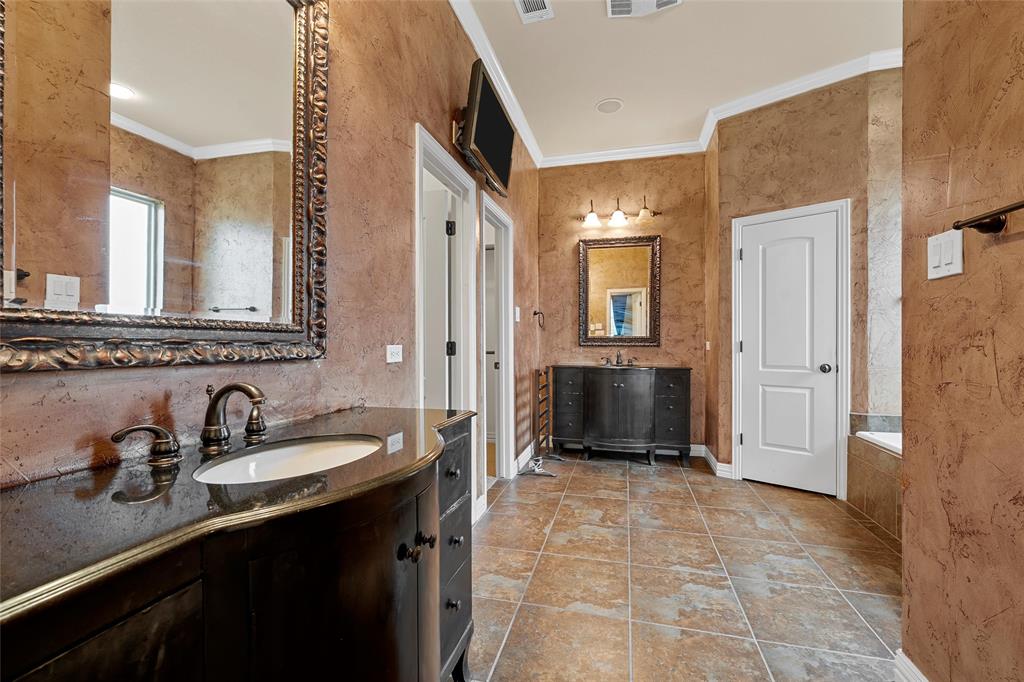 7030 Flagstone Circle Waco, TX 76657 - Photo 19 of 40 a spacious bathroom with a double vanity sink a mirror and a shower