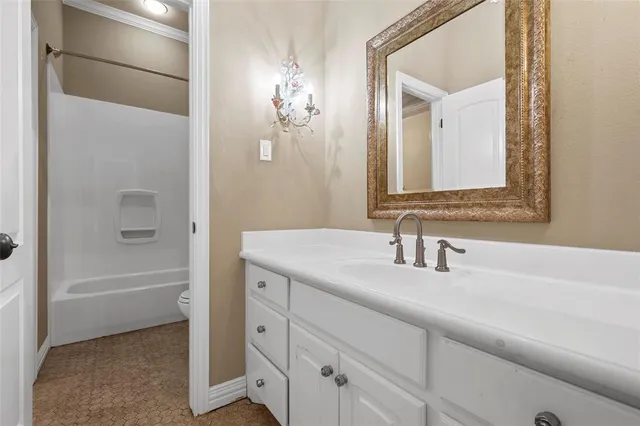 a bathroom with a bathtub a sink and a mirror
