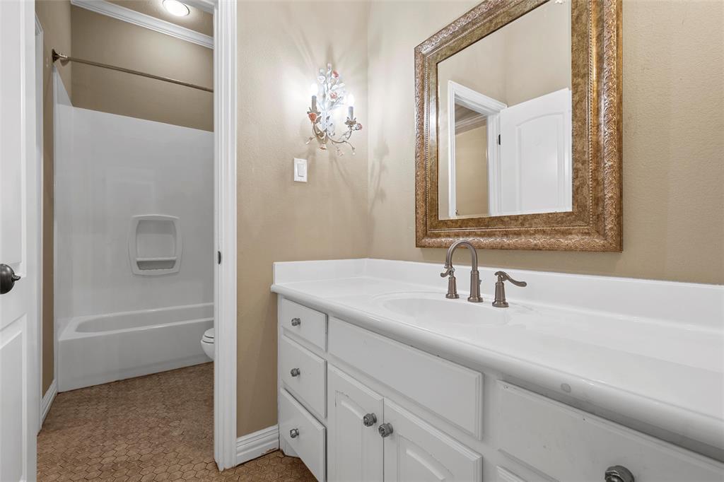 7030 Flagstone Circle Waco, TX 76657 - Photo 25 of 40 a bathroom with a bathtub a sink and a mirror