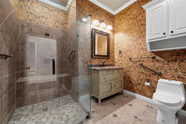 a bathroom with a granite countertop sink a toilet and shower