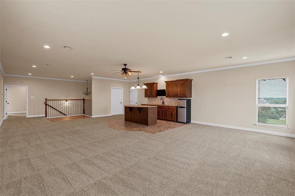 7030 Flagstone Circle Waco, TX 76657 - Photo 31 of 40 a large kitchen with stainless steel appliances a large counter top a stove and a refrigerator