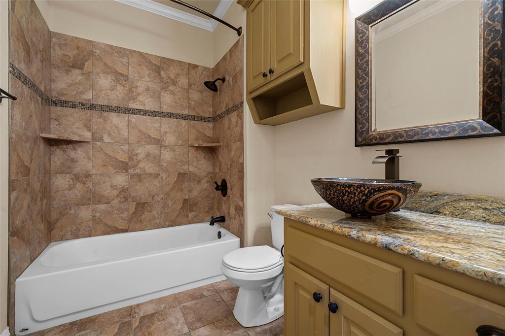 7030 Flagstone Circle Waco, TX 76657 - Photo 33 of 40 a bathroom with a granite countertop sink toilet and shower