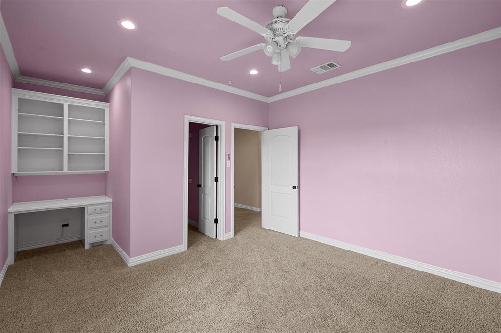 7030 Flagstone Circle Waco, TX 76657 - Photo 35 of 40 an empty room with a ceiling fan and windows