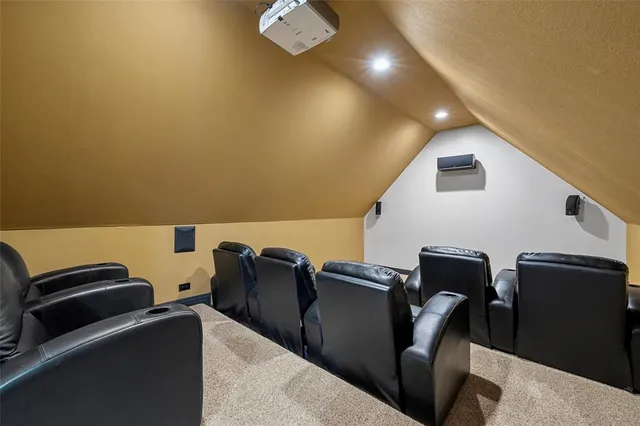 a large kitchen with stainless steel appliances granite countertop a stove top oven a sink dishwasher a dining table and chairs with wooden floor