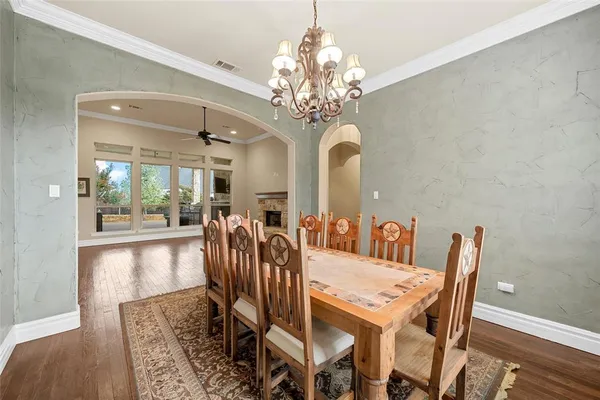 a view of a dining room with furniture and chandelier