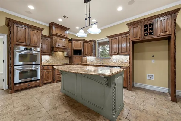 a kitchen with granite countertop a refrigerator a stove and a sink