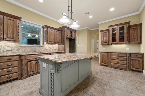 a kitchen with a stove kitchen island and fireplace