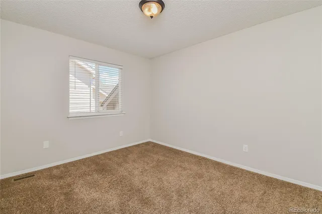 a bathroom with a granite countertop sink a toilet a mirror a bathtub and shower